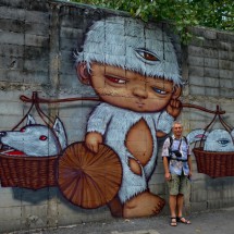 Alfred with a mural in Bangkok's Chinatown